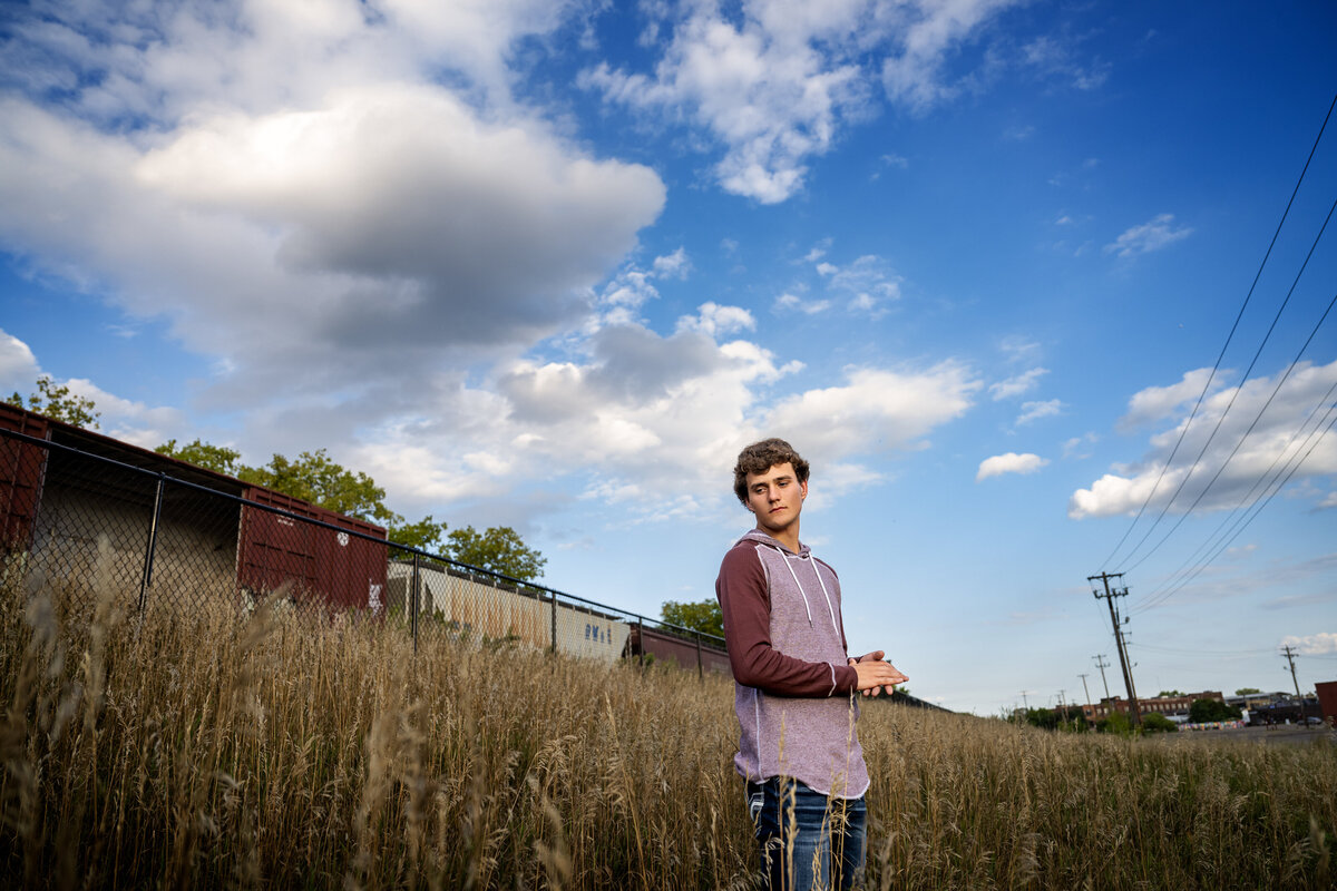 Princeton Minnesota high school senior  photo of boy in field with trains