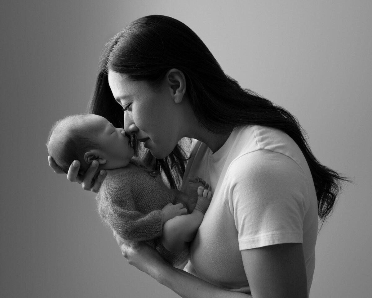 Black white mother holding newborn Liberty Hill lifestyle family photographer