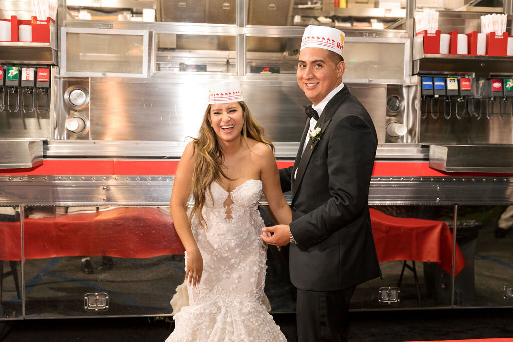 Bride and groom eating in and out burgers at Bel Air Bay Club