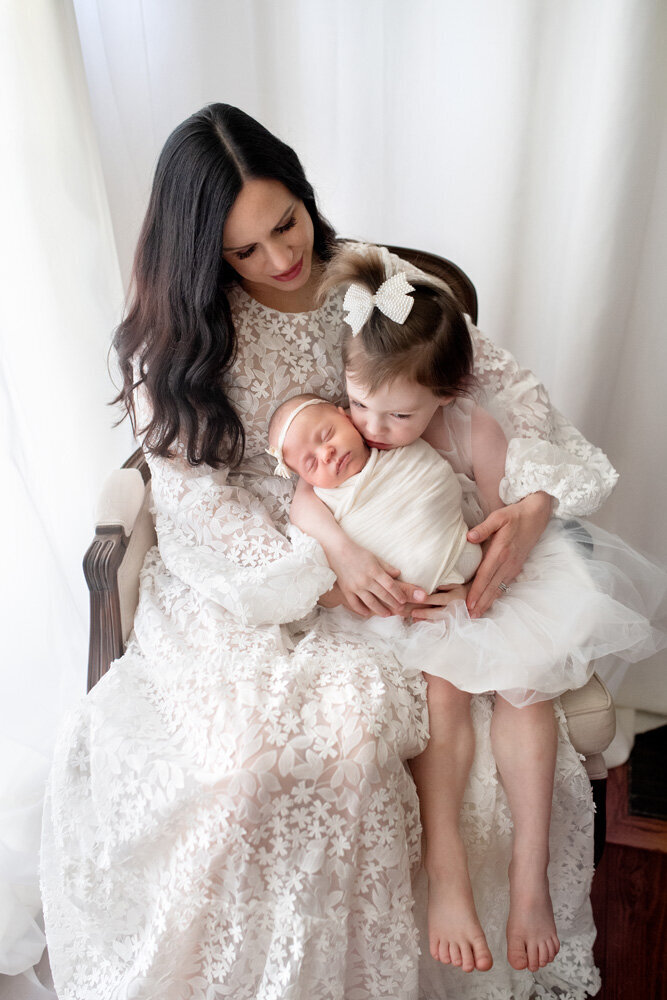 Newborn session with mother and two daughters in dresses