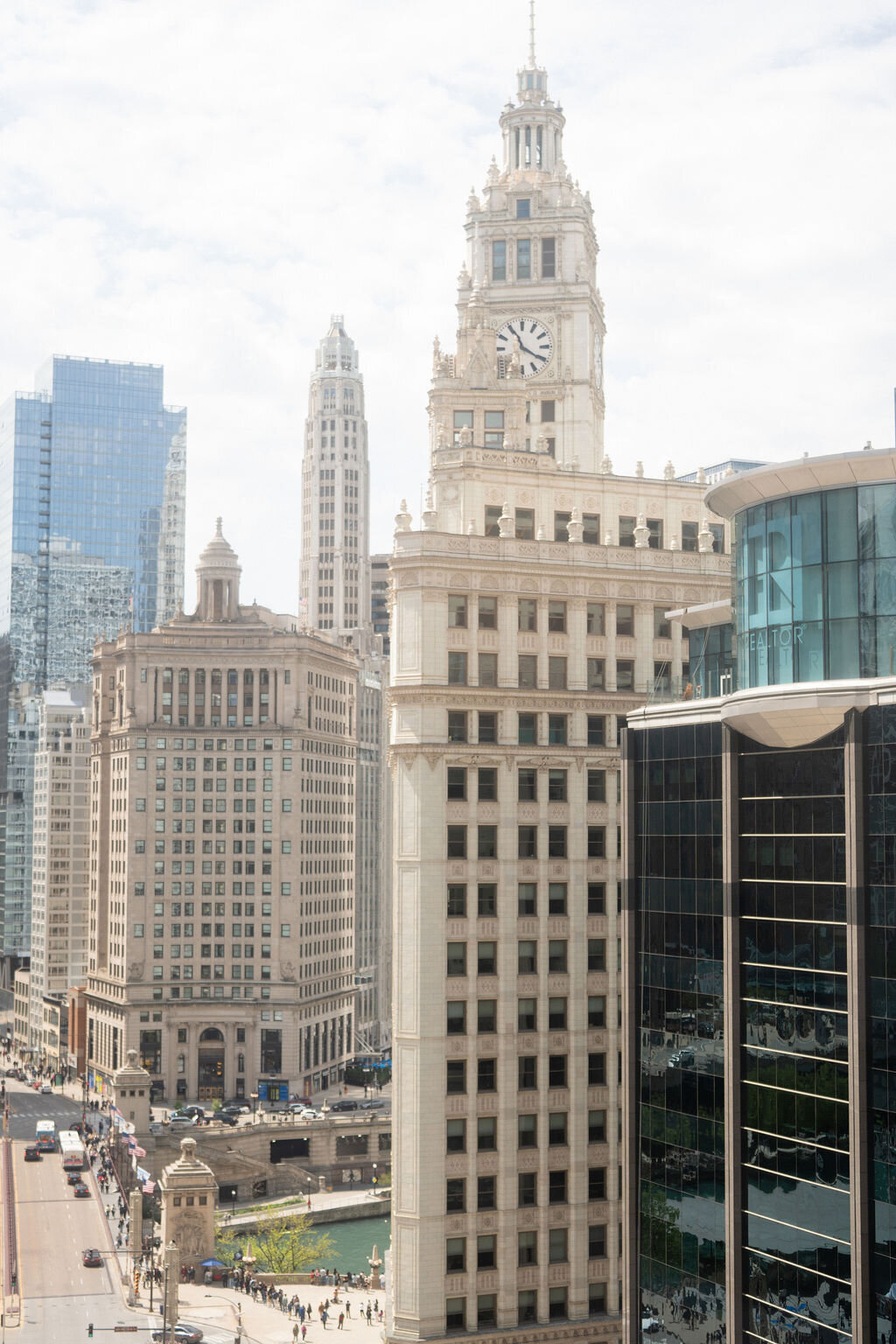Bride and groom standing at the Wrigley Building in a Gown and Tux, taken by Chicago film wedding photographer Allison Francois