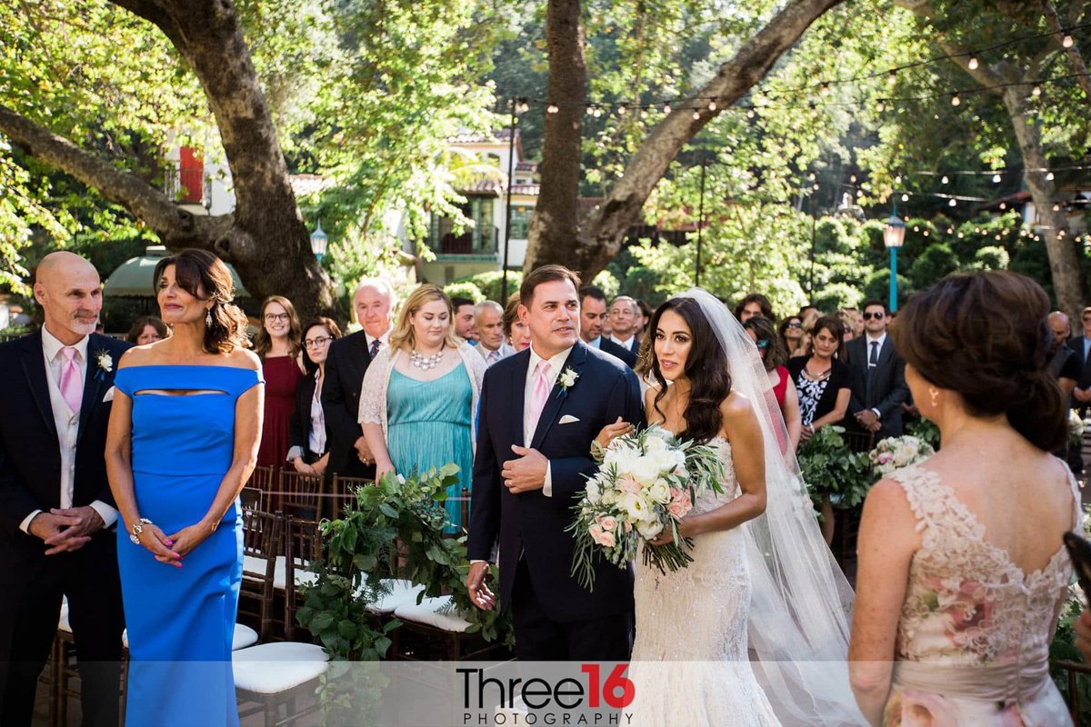 Bride being escorted to the altar by her father