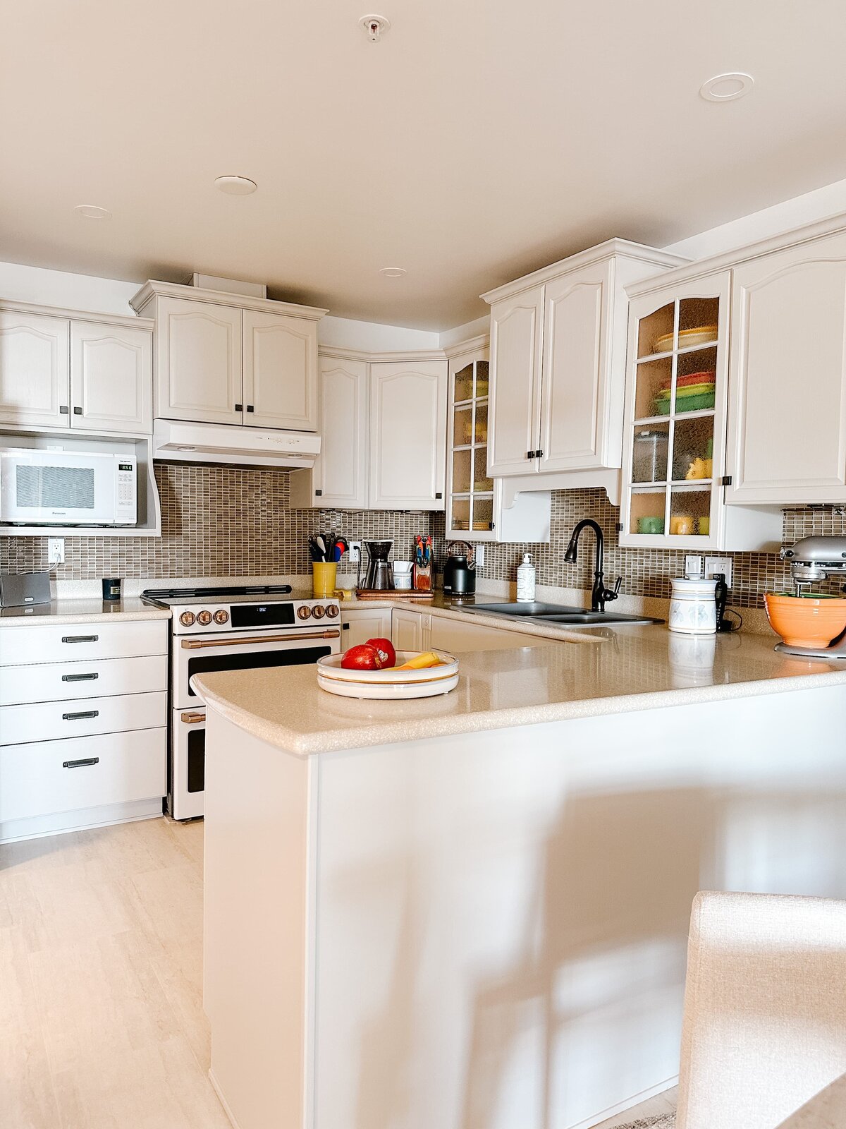 Traditional kitchen renovation with pendant lighting, dining nook and cafe appliances by Hanbury Design Co.