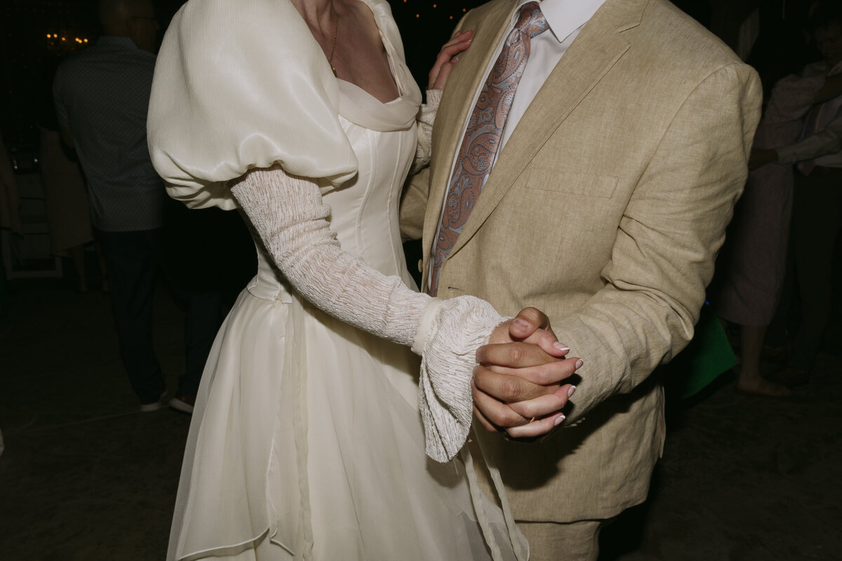 Bride and groom slow dancing together during their wedding reception.