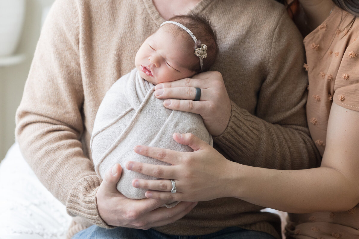Parents cradle a newborn during their South Jersey Newborn Photo Session