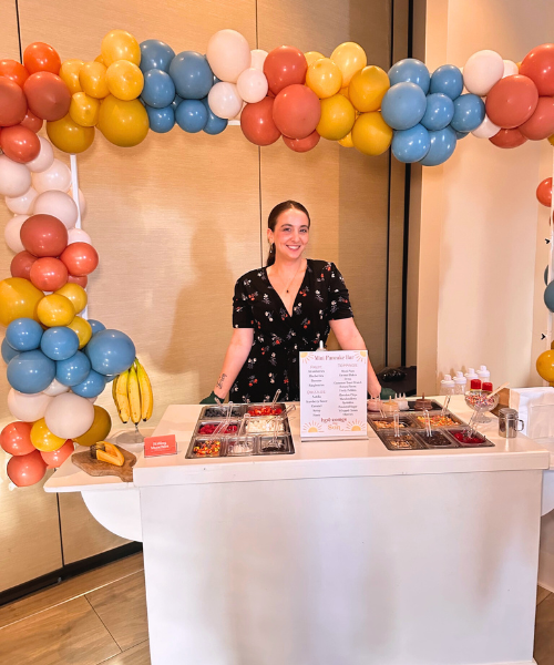 Breakfast snack cart with colorful balloon arch