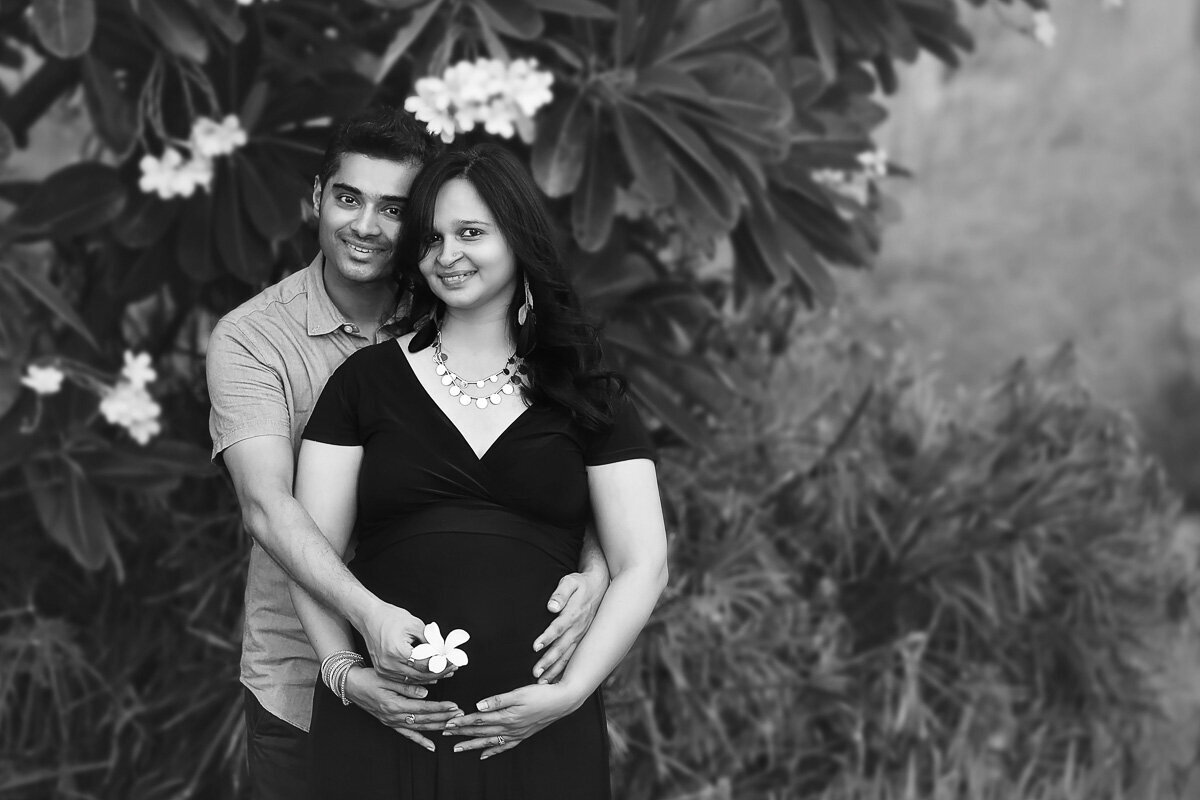 Pregnant couple cuddling in black and white portrait by Vancouver Family photographer.