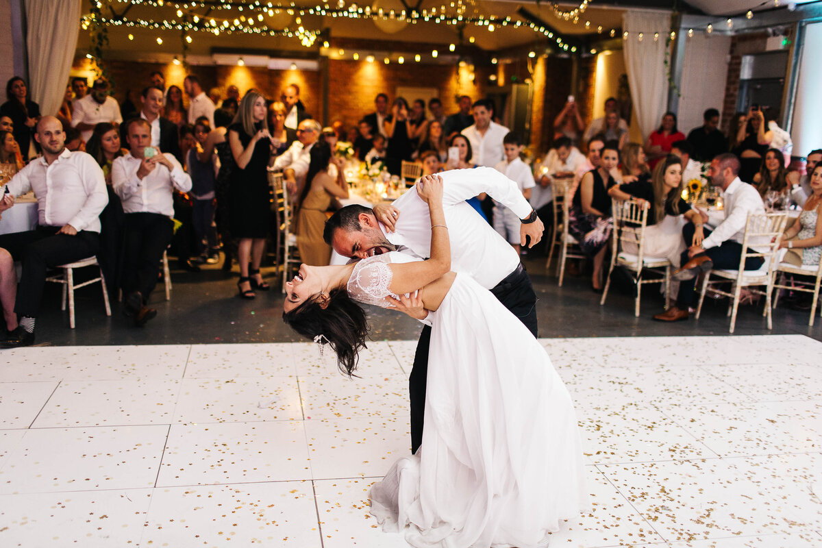 Groom dipping his bride during their first dance in Leeds