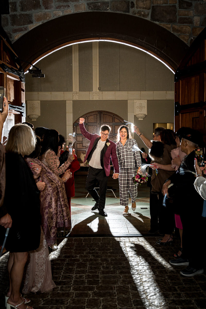 The bride and groom make their grand exit at Casa Real, surrounded by cheering guests and a celebration of love as they step into their new journey together.