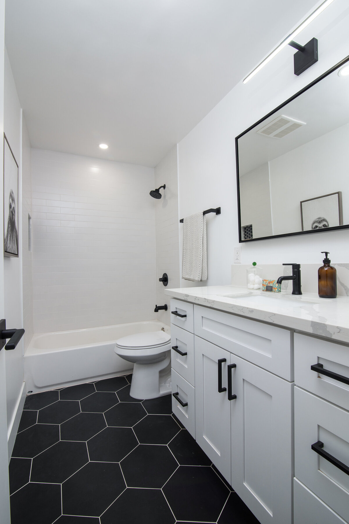 black-and-white-bathroom-design-with-hexagon-tile-and-modern-fixtures-aw-development