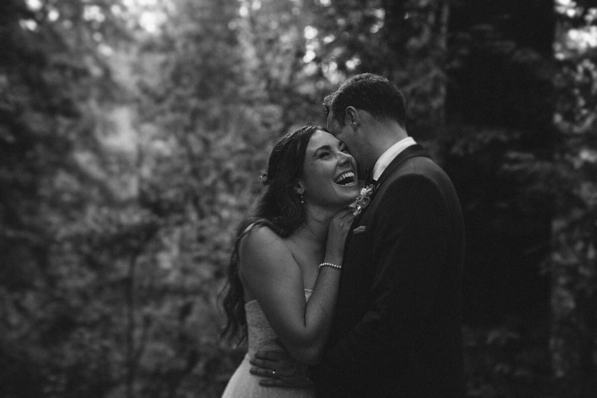 black and white image bride and groom embracing