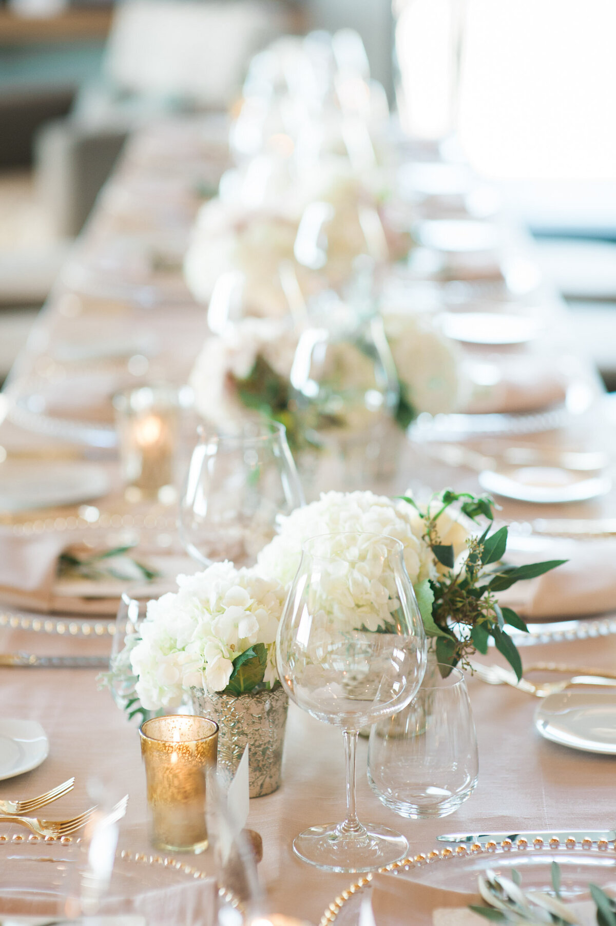white wedding flowers in small bud vases on tables at ponzi winery wedding