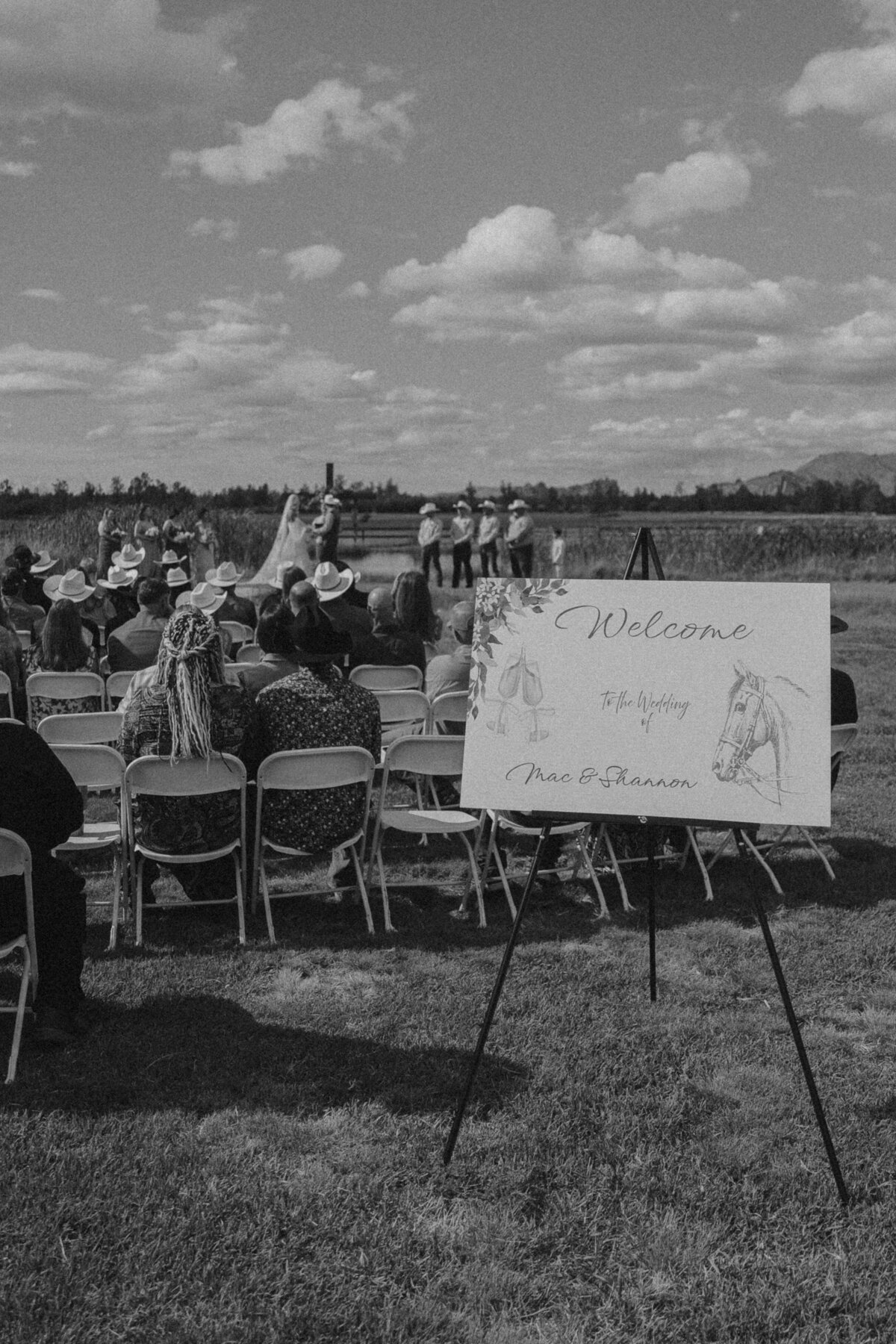 Outdoor Ceremony with Cowboy Hats and Rustic Welcome Sign | Oregon Ranch Wedding Ceremony