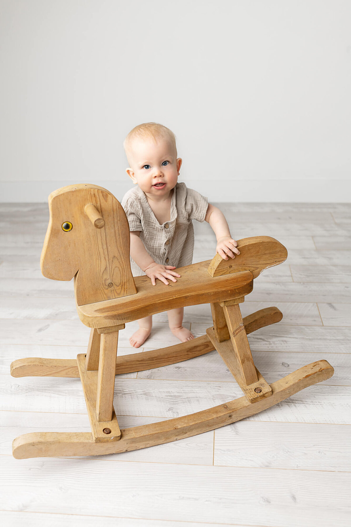 baby boy and rocking horse