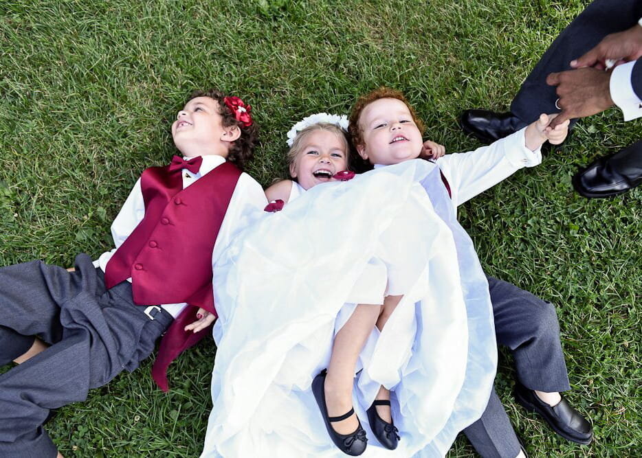 Playful Wedding Kids Lying on the Grass