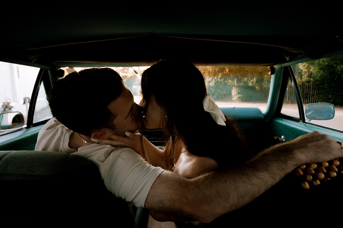 Couple kissing in a car for editorial photographer in Columbia, SC