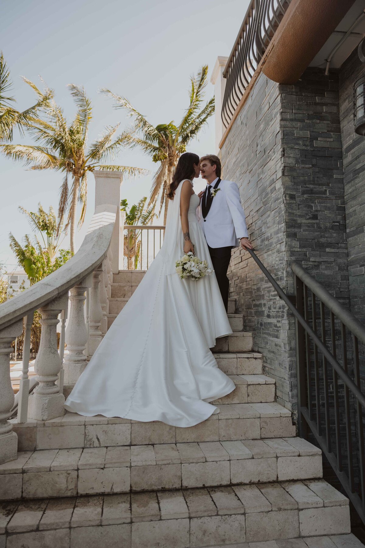 A bride and groom pose at the Palm Ceia Presbyterian Church in Tampa, Florida