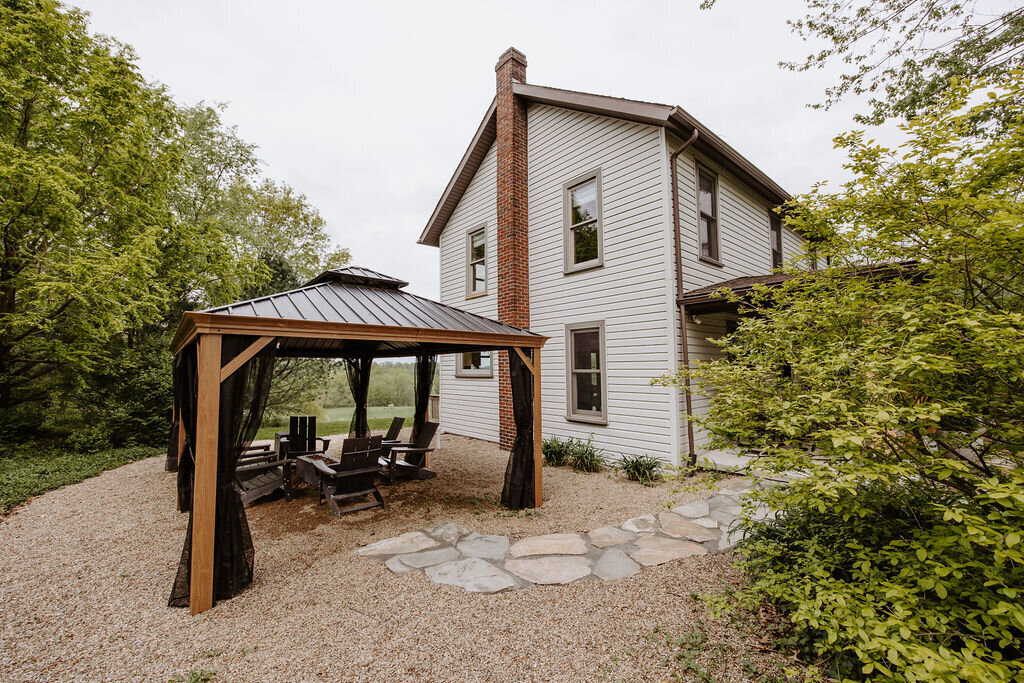 the modern farmhouse overnight accommodations and the pergola with outdoor firepit and slate path at Willowbrook wedding venue