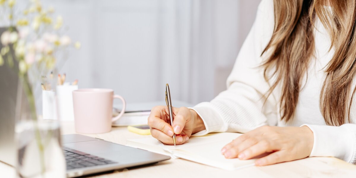 Women taking notes during photography education course at home for virtual mentorship by york pa photographer