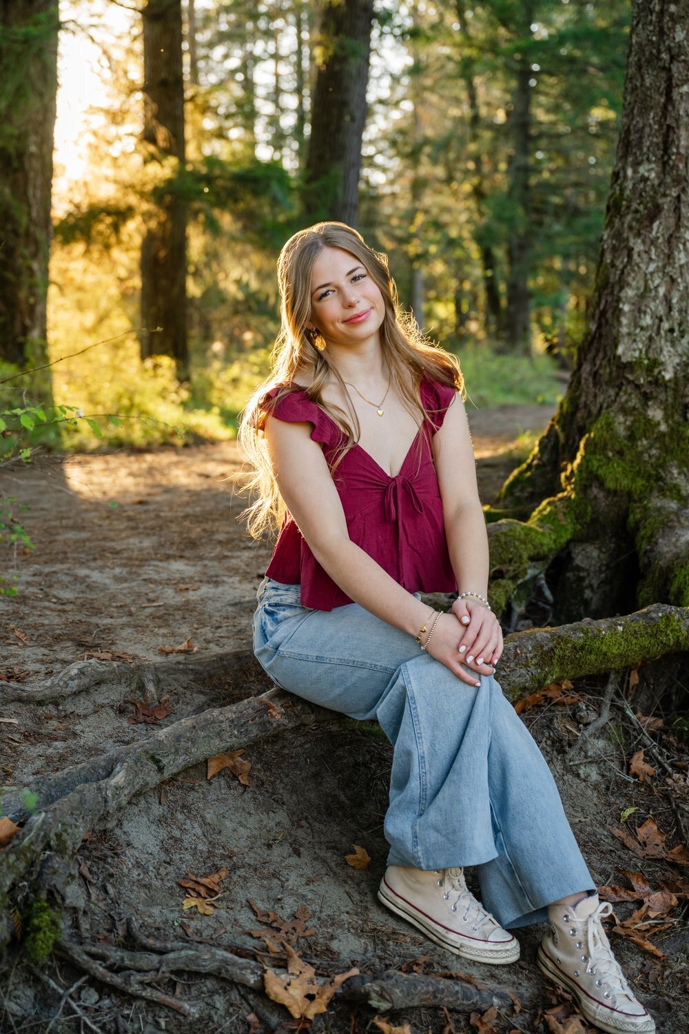 north bend senior girl seated in forest