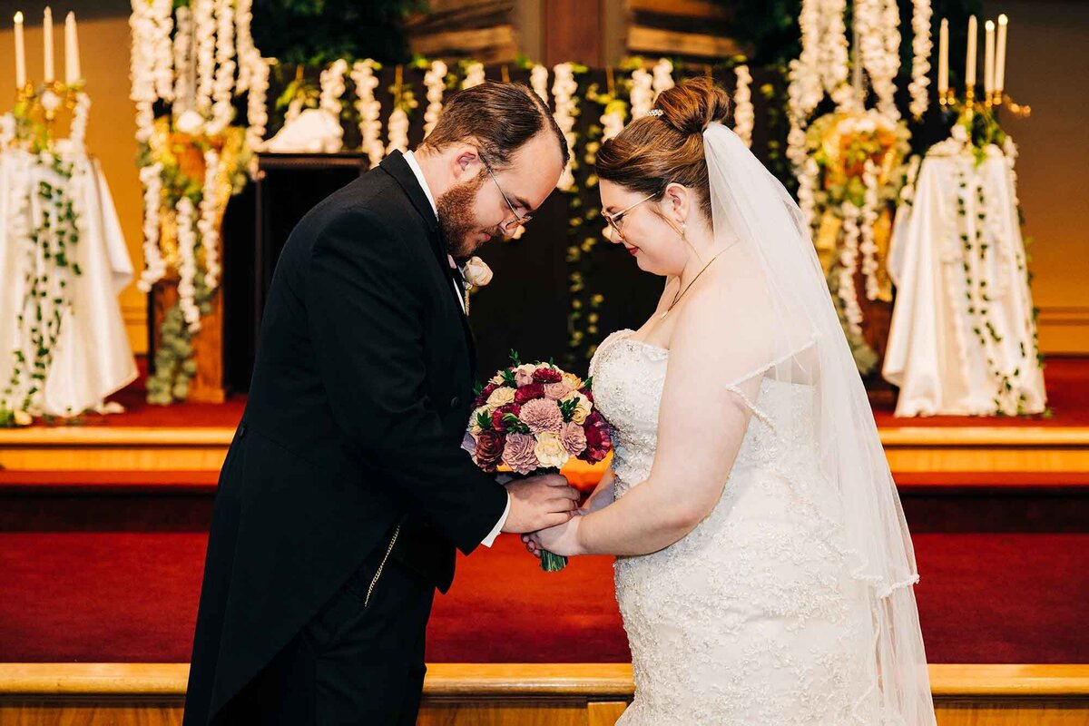 Bride and groom touching foreheads at church in Helena, MT