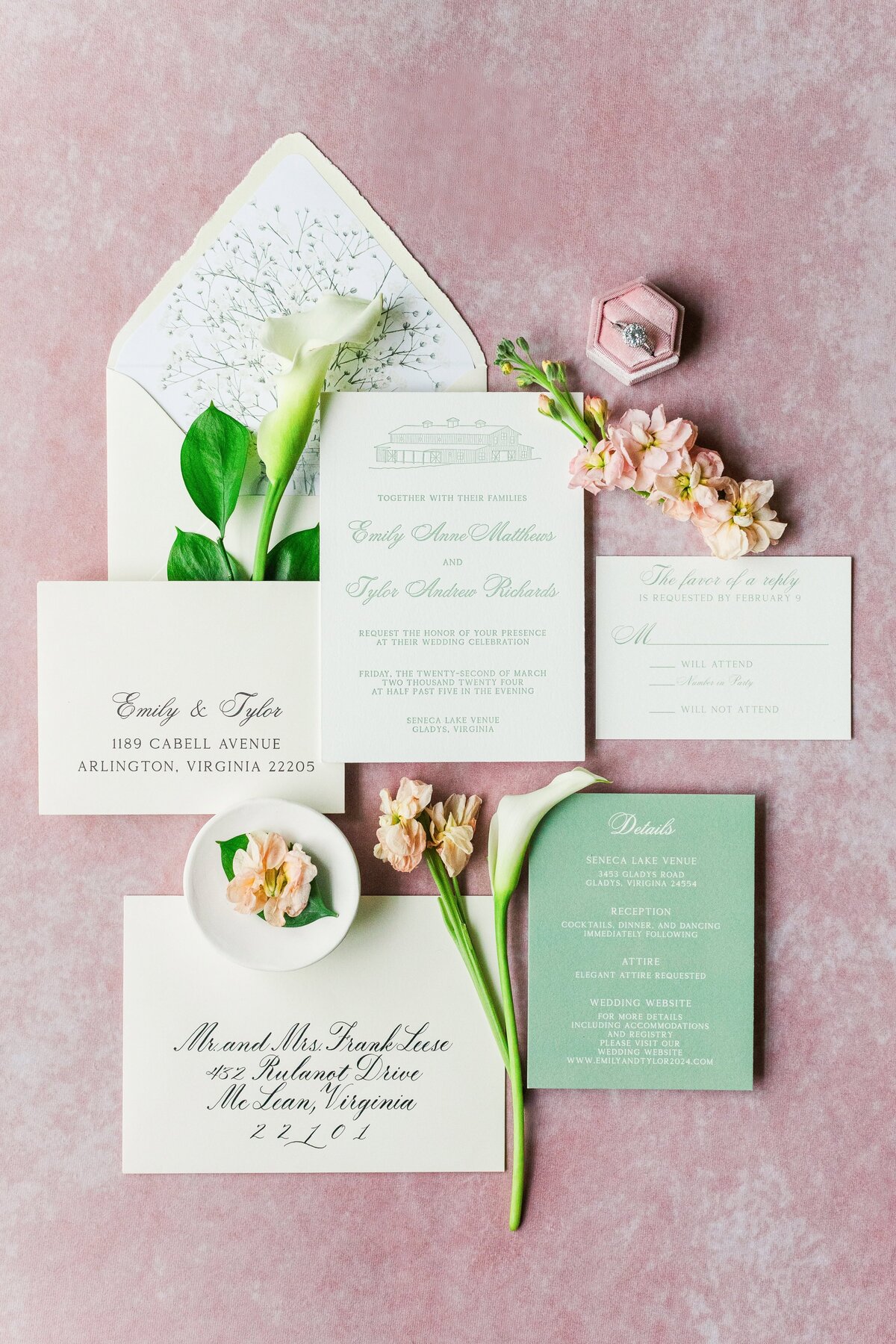 Flatlay of a green and white wedding invitation suite 