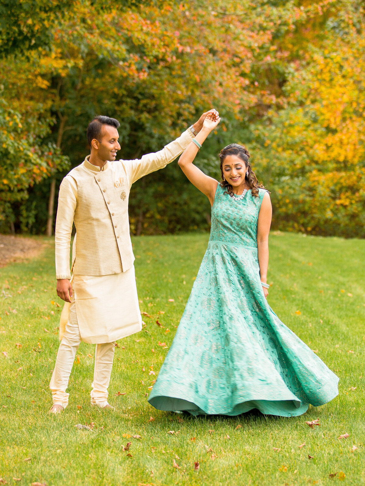 Indian couple dance during engagement session.