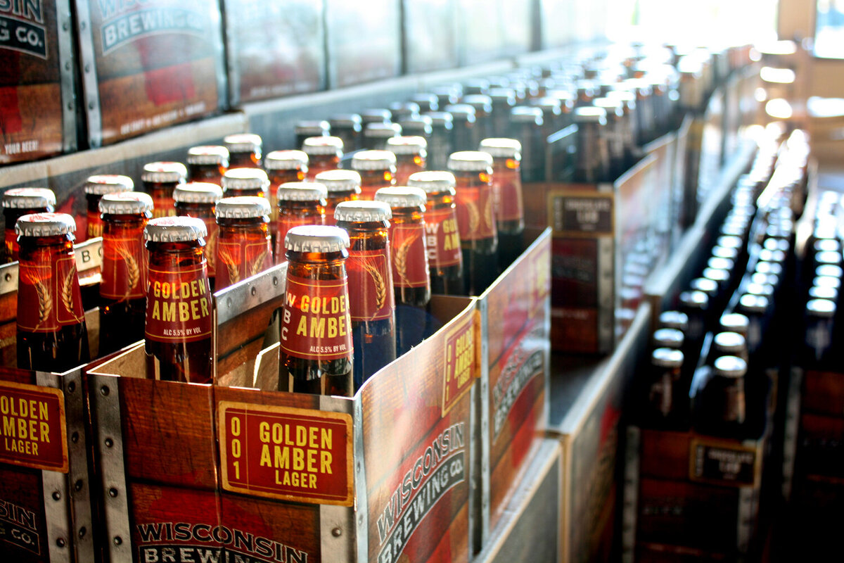 Packs of Golden Amber Lager beer bottles in the sunlight