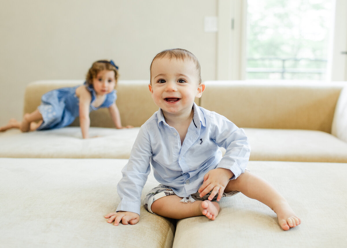 Siblings smiling and crawling.