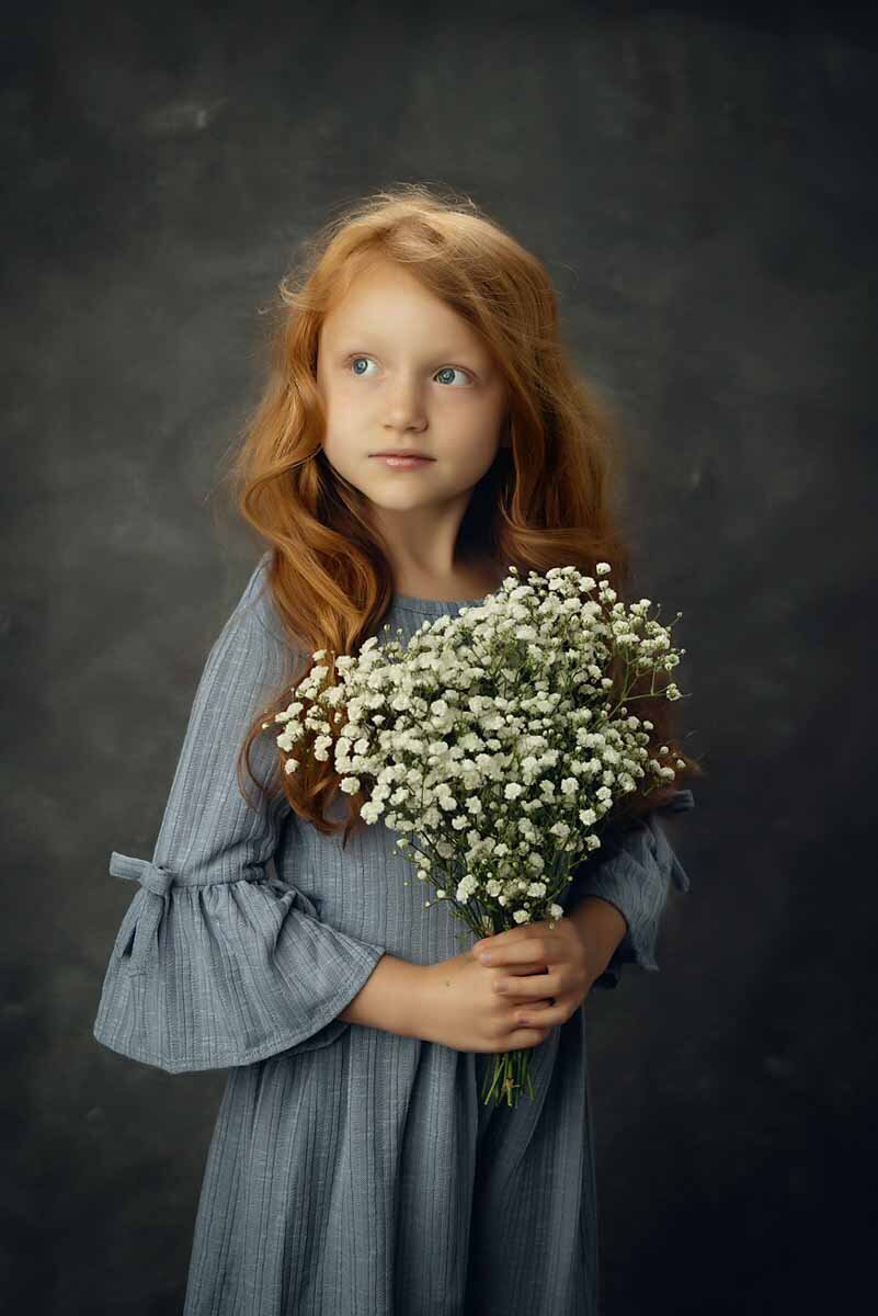 Child holding flowers in children's portrait