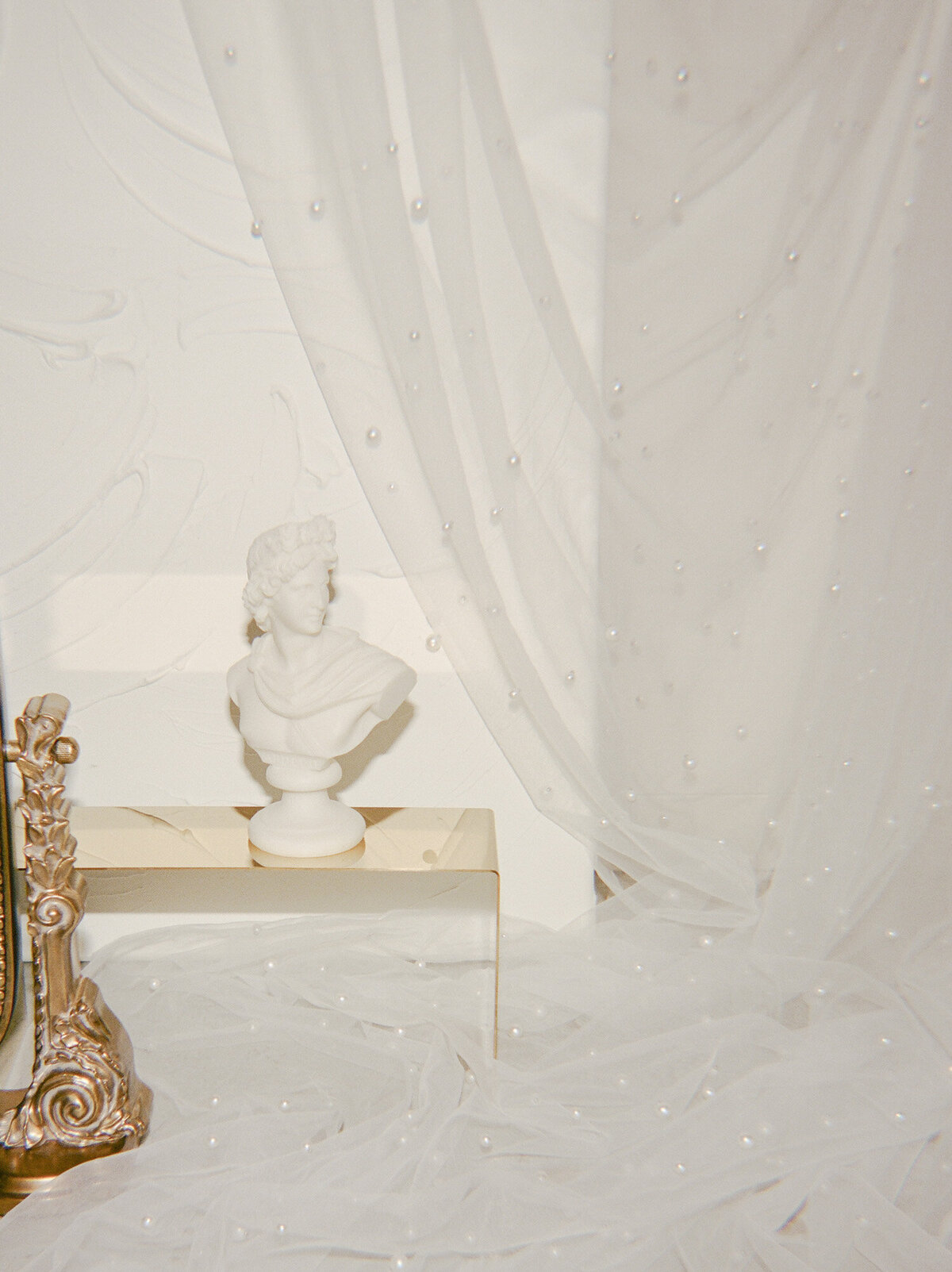 editorial film brand photography, sculpture bust candle, ornate gold detail, white space