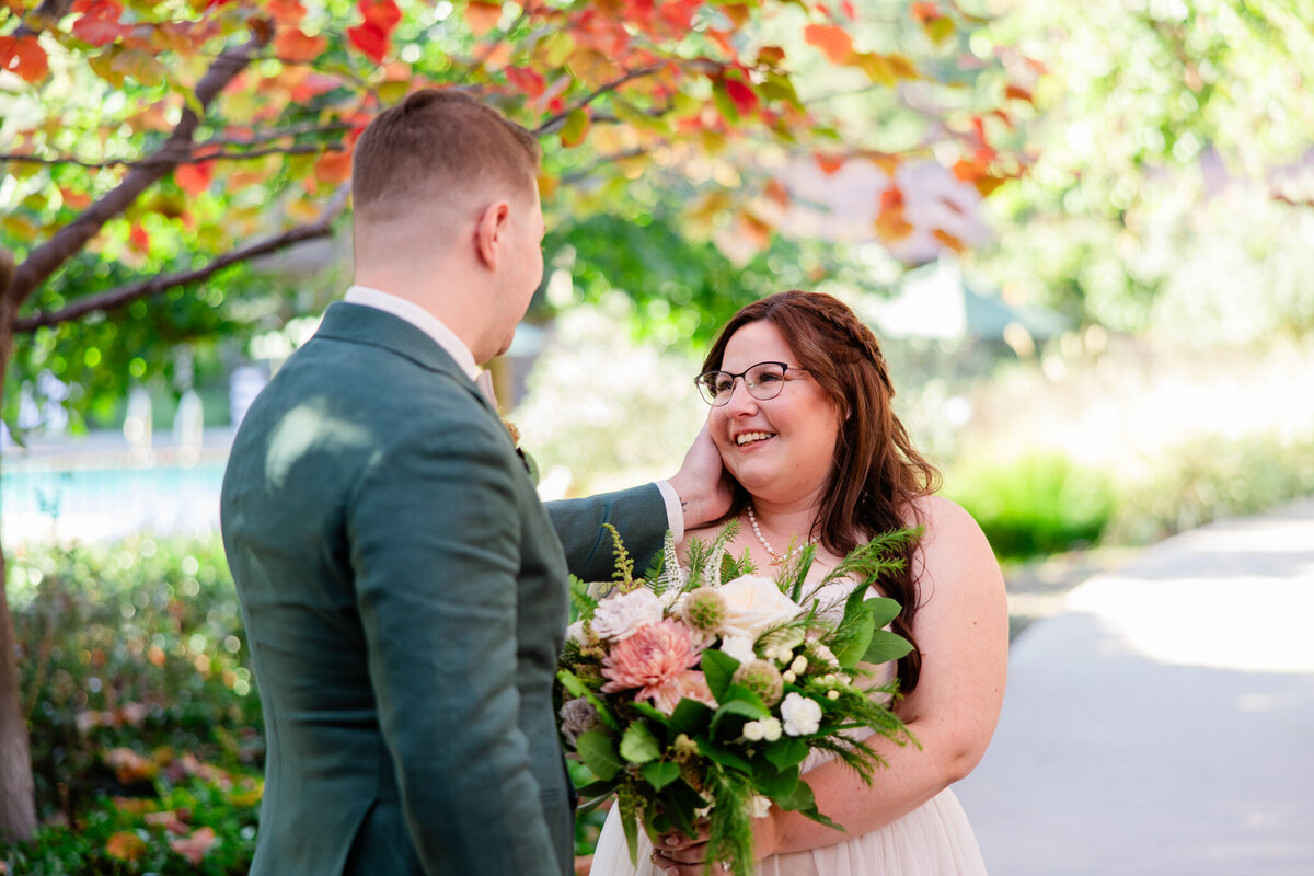 groom admires bride during first look 2