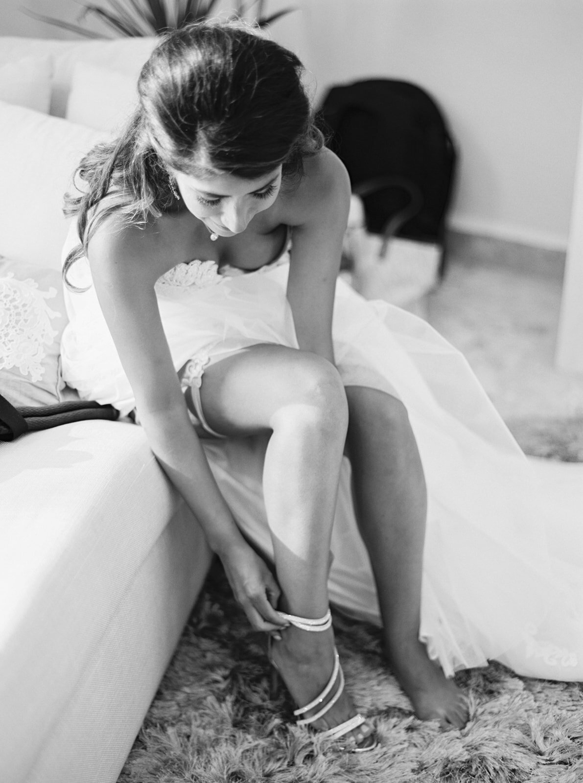 a bride putting on her bridal shoes
