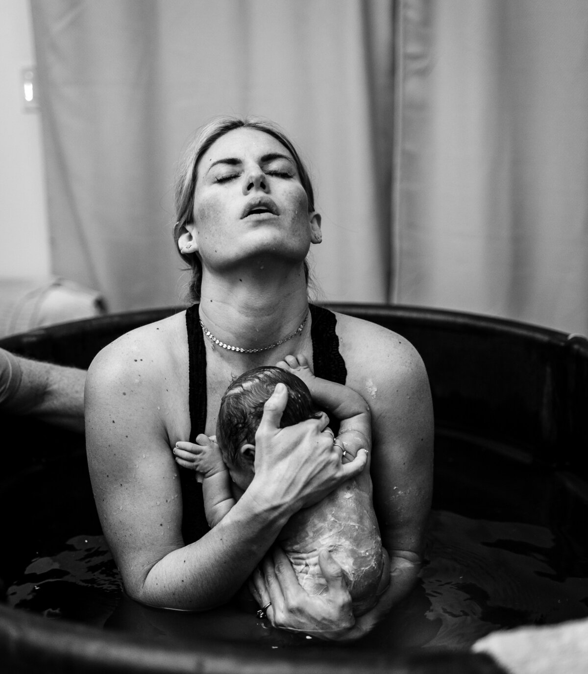A peaceful scene of a baby being brought into the world, surrounded by warmth and love, highlighting the calm yet extraordinary nature of birth.