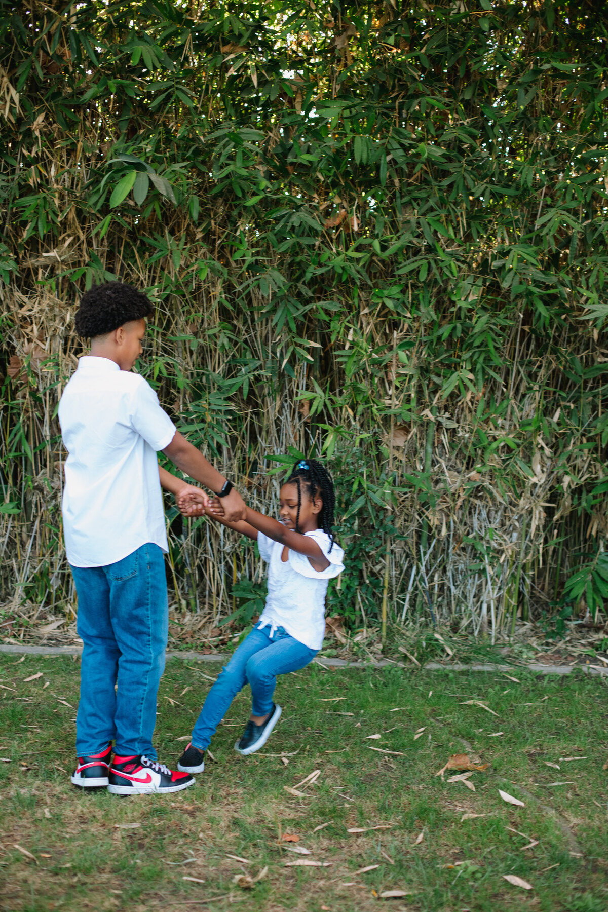 brother and sister playing during family session