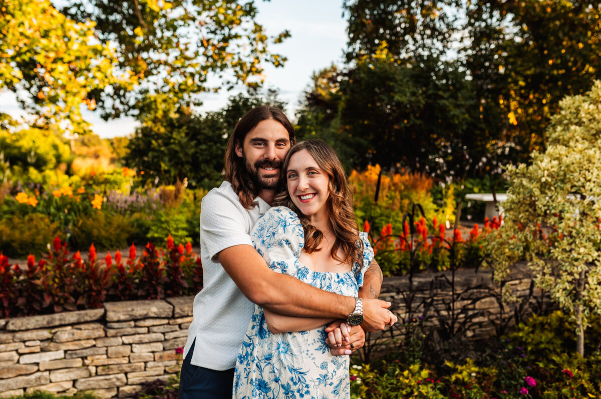 Family hugging in a colourful garden during Ottawa summer mini session.