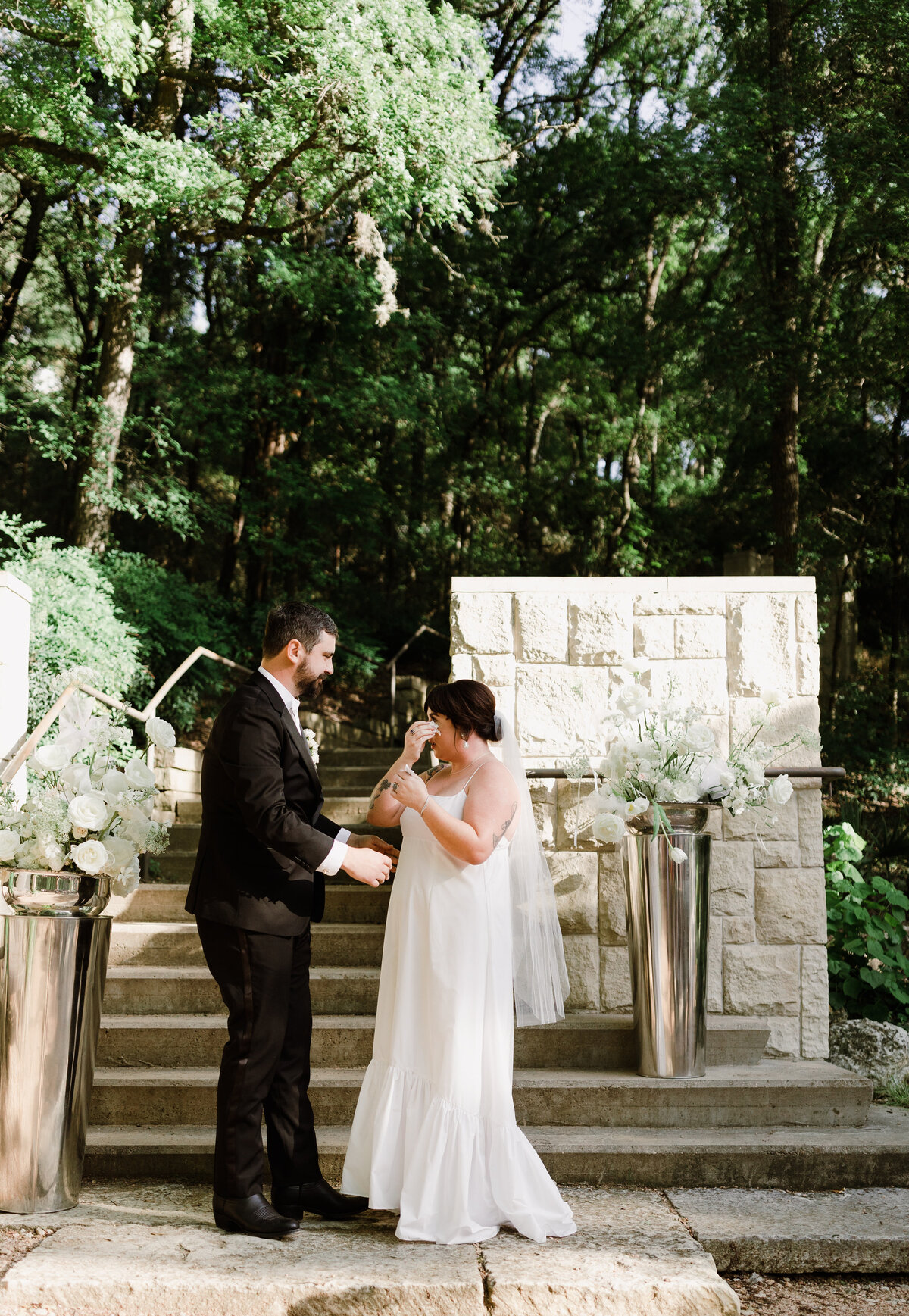 Bride wiping away tears at Umlauf Sculpture Garden, Austin