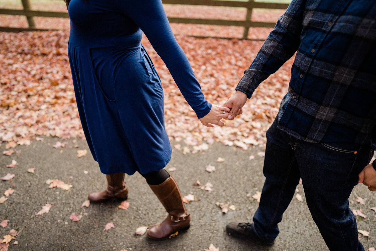 Couple holding hands in the fall, at Rockwood Farm, best spot for engagement pictures in Seattle