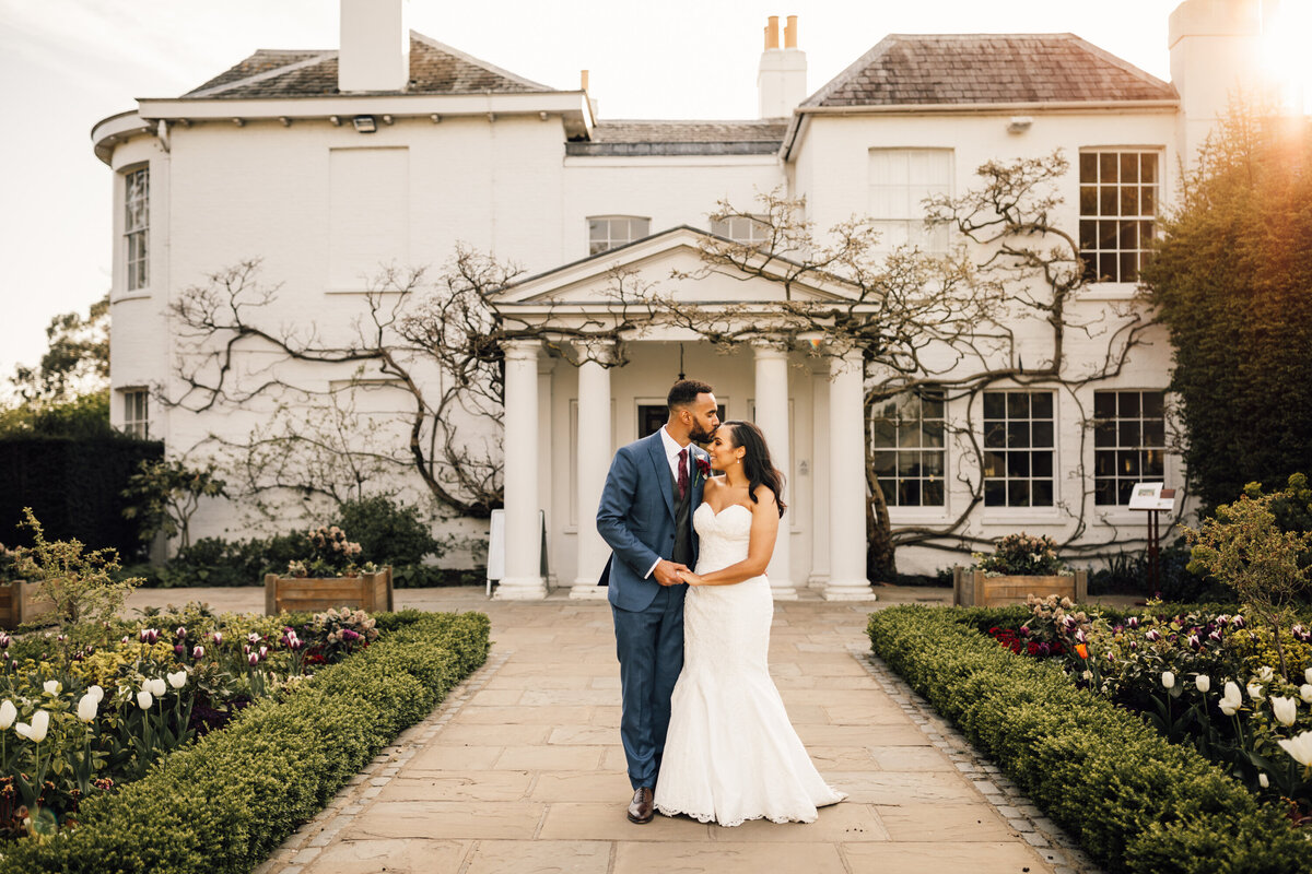Couple strolling in villa gardens for wedding portrait