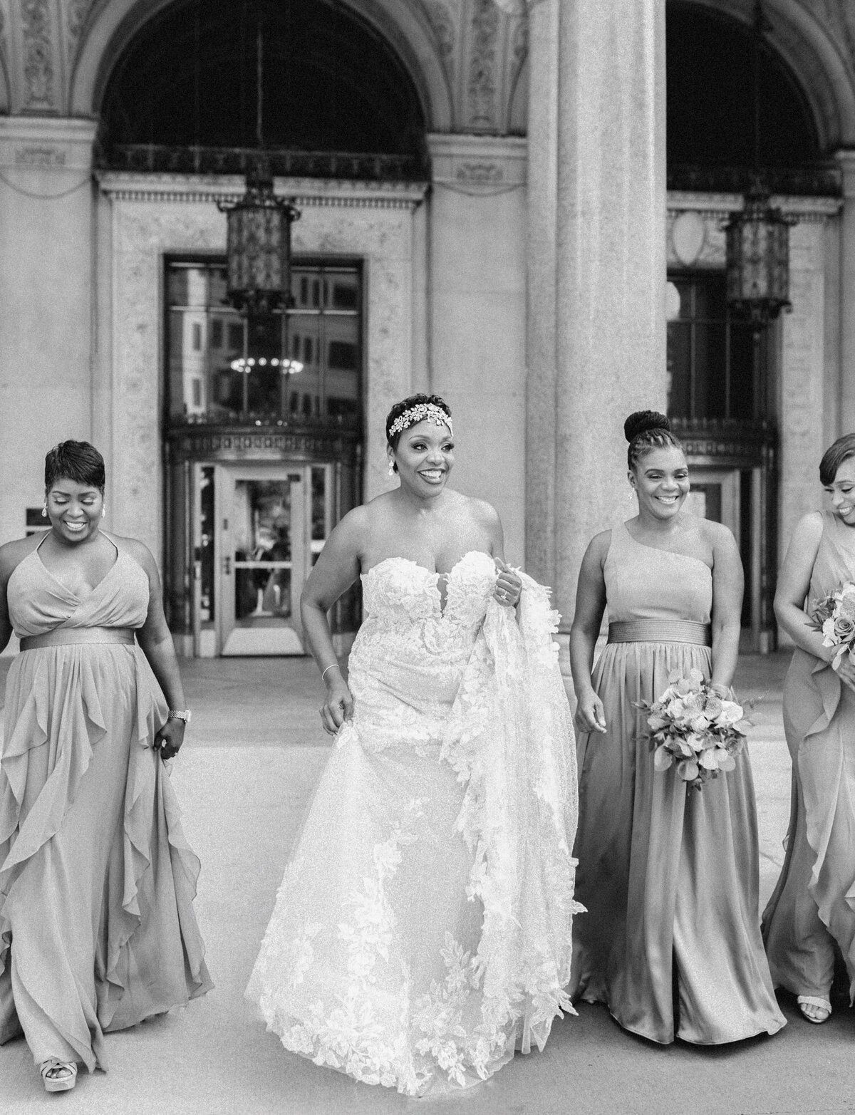 black bride in strapless lace wedding dress with bridesmaids and Detroit architecture
