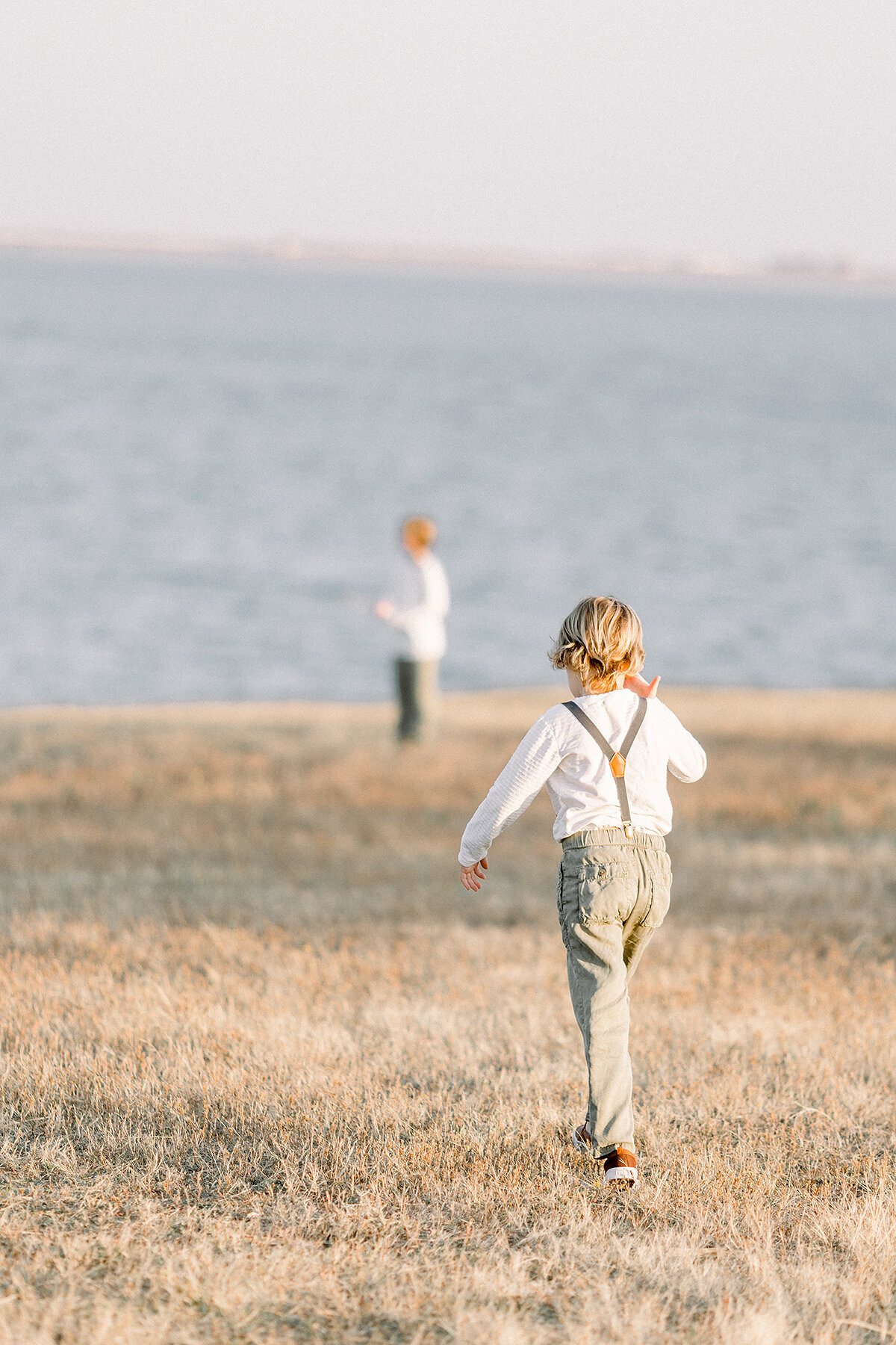 Two brothers walking off together towards a DFW Lake.