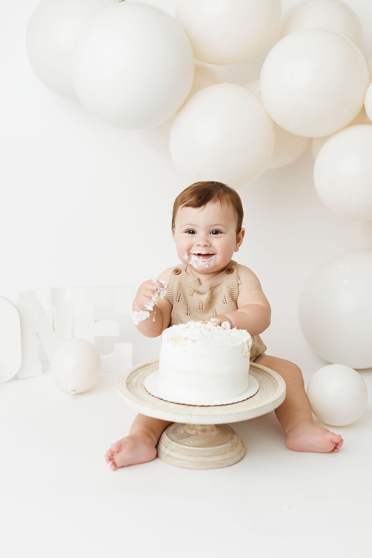 smilingbabywithhandsincake