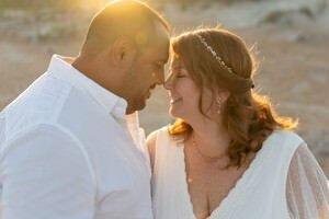Intimate couple embracing at golden hour captured by St Augustine elopement photographers with historic stone architecture backdrop