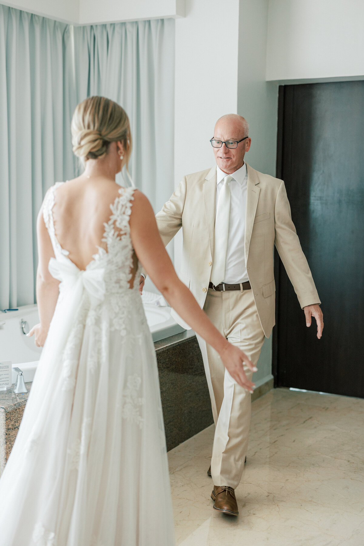 Bride’s emotional first look with father before Cancun wedding, captured by Philadelphia wedding photographer.