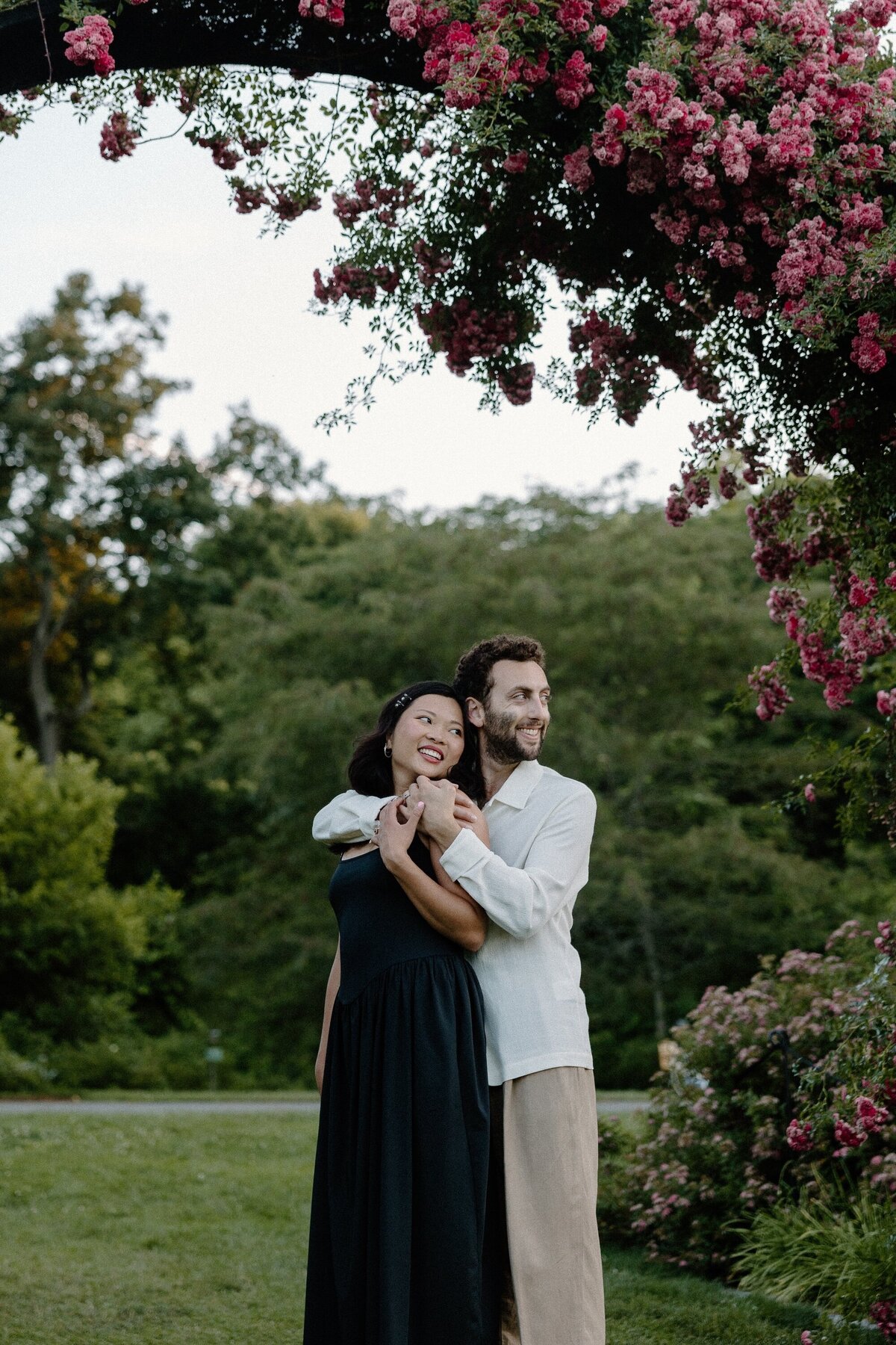 engaged couple under arch