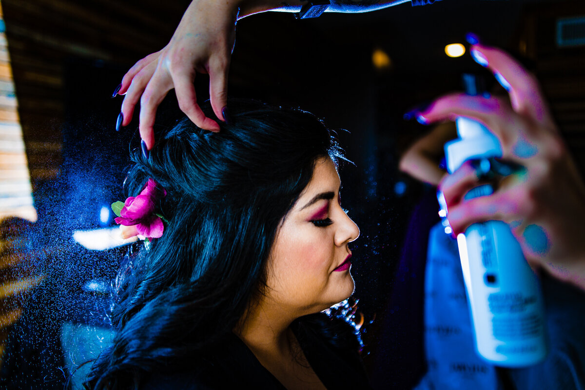 One of the top wedding photos of 2020. Taken by Adore Wedding Photography- Toledo, Ohio Wedding Photographers. This photo is of bride getting her hair sprayed in the morning before the wedding ceremony in Detroit Michigan