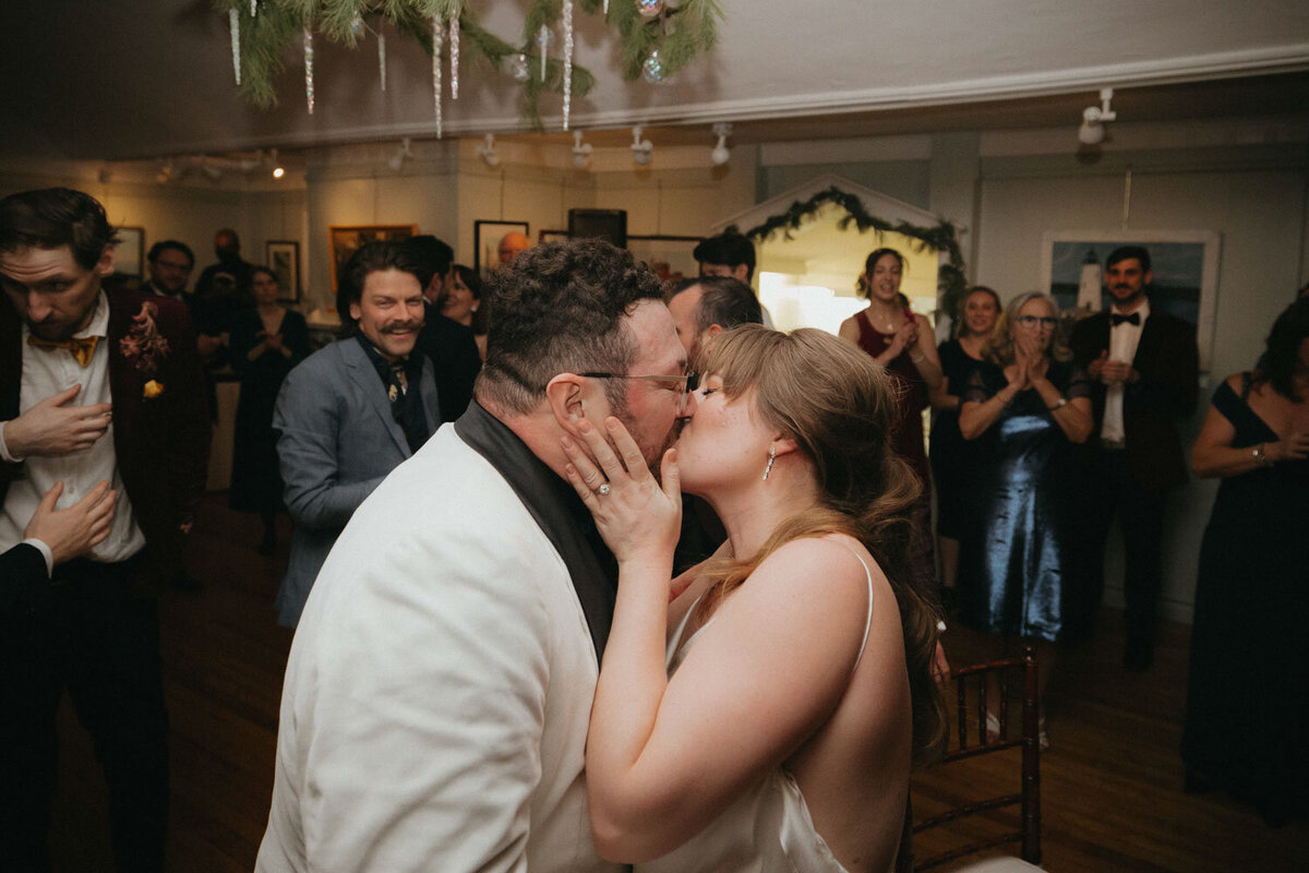 Bride and groom kissing during their wedding reception