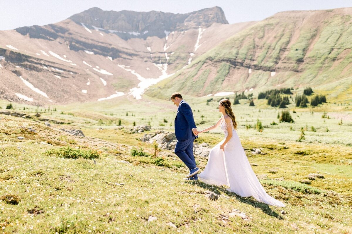 Bride-and-groom-walking-towards-their-helicopter-with-Mount-Charles-Stewart-behind-them