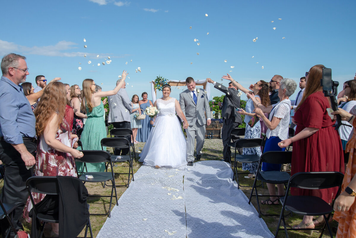 Bride and Groom walking out with confetti