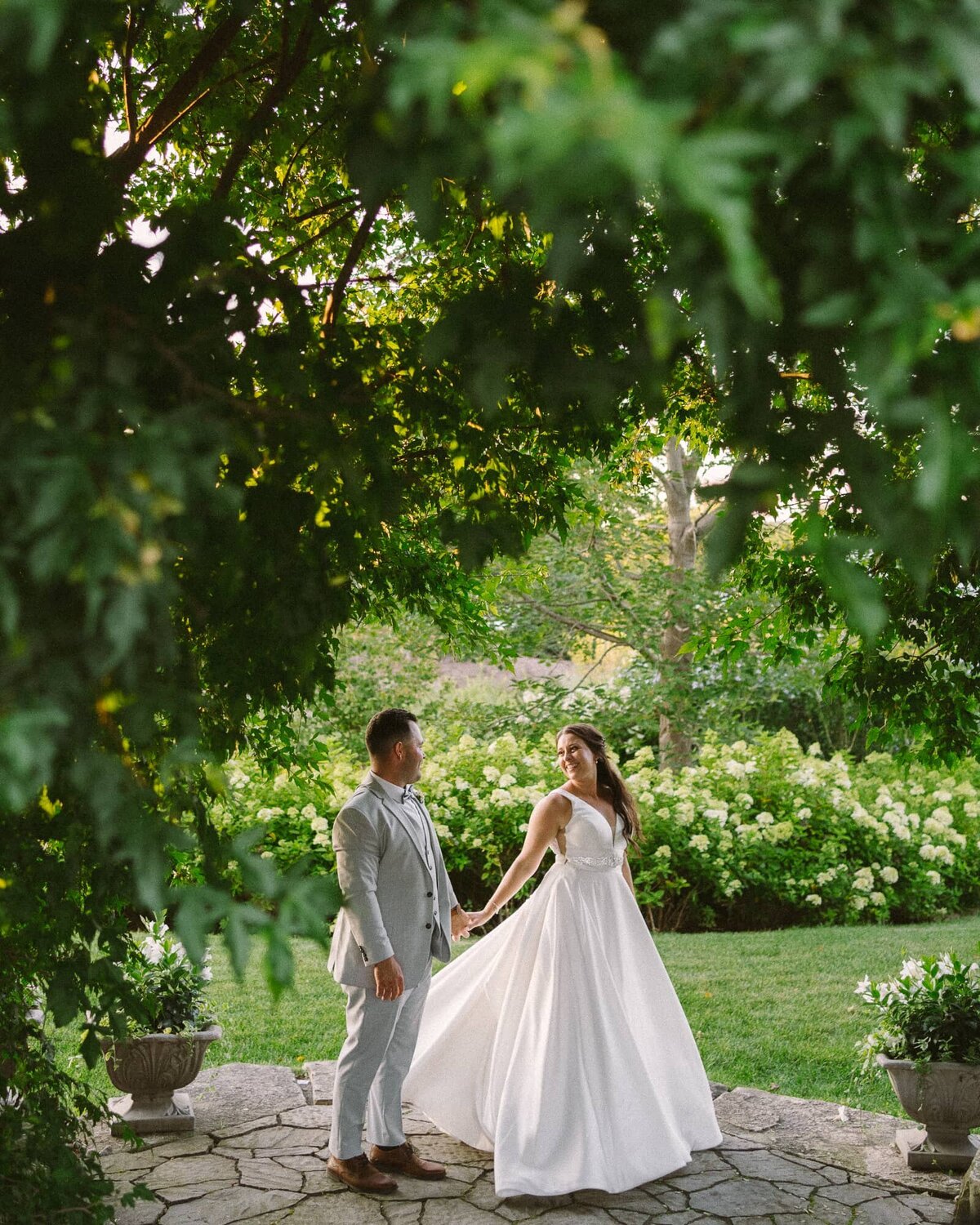 married couple dancing together in a garden